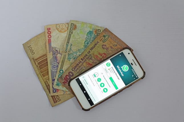 white Android smartphone beside banknotes